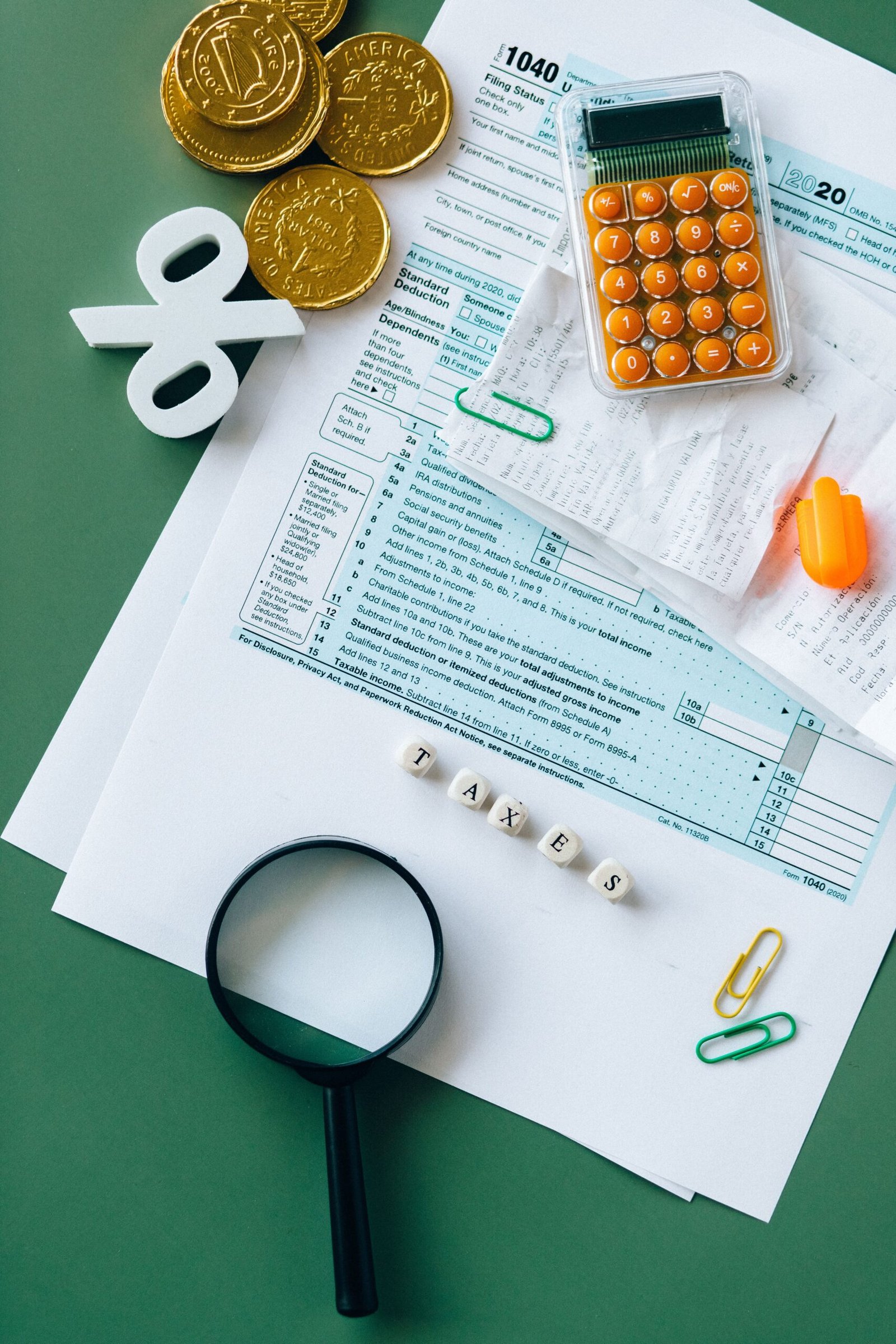 Tax computation documents, calculator and coins on a desk