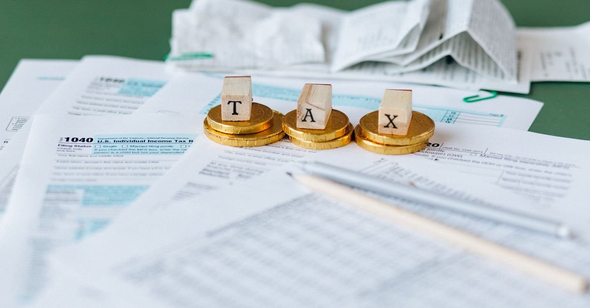 Tax forms, receipts, and calculator representing partnership tax computation