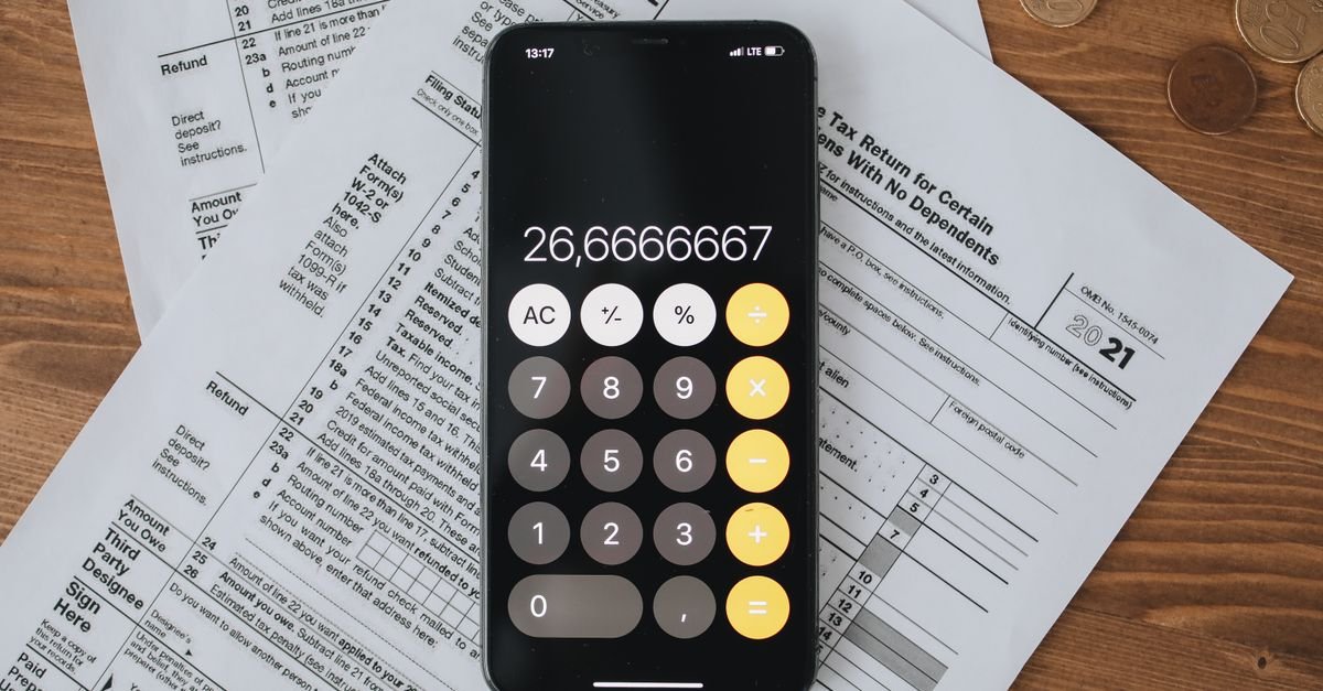 Calculator on tax documents, representing capital allowance computation under Ghana's Income Tax Act 896 for CITG students