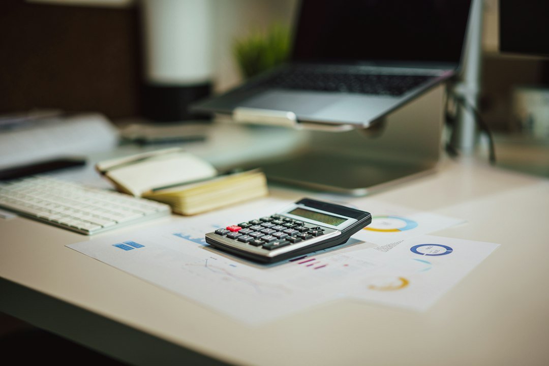 Calculator on a desk with tax documents for studying Ghana income splitting rules